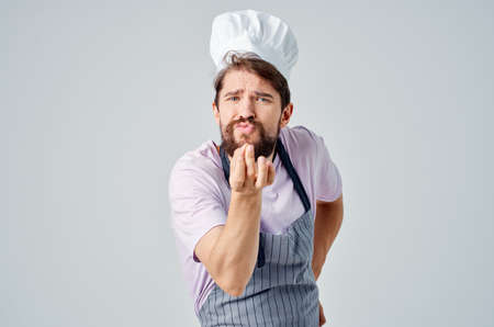 man in chefs uniform cooking restaurant kitchen professionalsの写真素材
