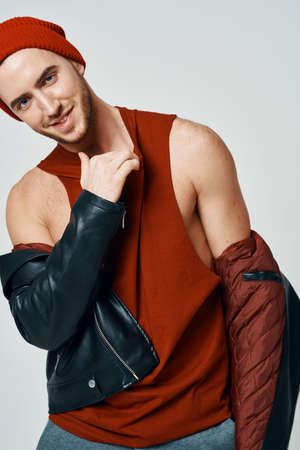 cute fashion men in red hat leather jacket posing modern style