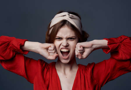 woman in red dress headband posing elegant style dark background