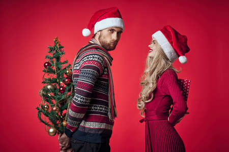 emotional man and woman gifts christmas new year red backgroundの写真素材