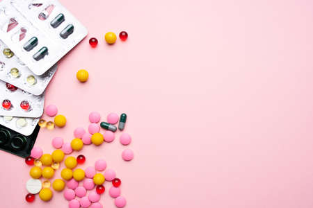 colorful pills packaging vitamins health care pink backgroundの写真素材