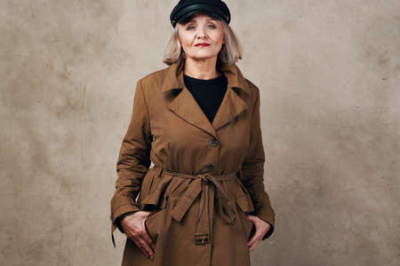pretty elderly woman in coat black hat fashionの写真素材
