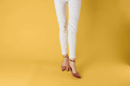female feet white sneakers posing modern style fashionの写真素材