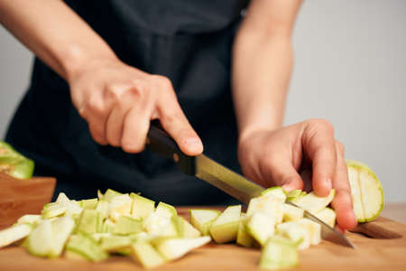 housewife cutting vegetables healthy eating vitamins in the kitchenの写真素材