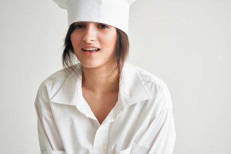 woman in chefs uniform flour products rolling dough homeworkの写真素材