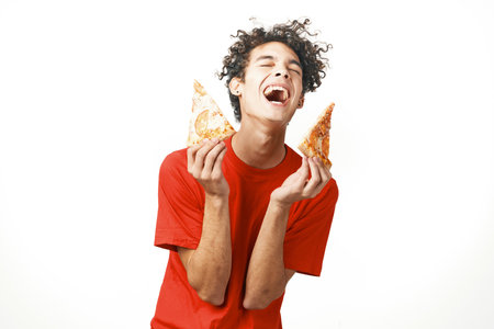guy in red t-shirt fast food diet food snack light backgroundの写真素材