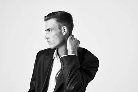 handsome man in suit fashion hairstyle posing lifestyle light backgroundの写真素材