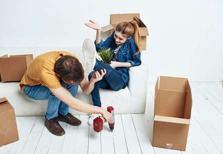 family in a new apartment renovating boxes with things
