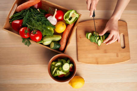 cutting fresh vegetables on a cutting board kitchen healthy eating at home. High quality photoの写真素材