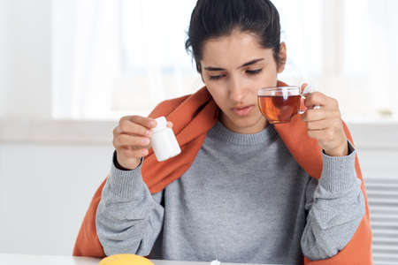 woman miss in hands medication treatment flu infectionの写真素材