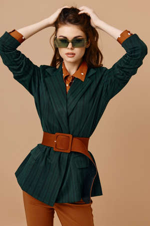 woman wearing sunglasses suit beige background modelの写真素材