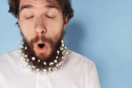 handsome man with flowers in beard hair care lifestyleの写真素材