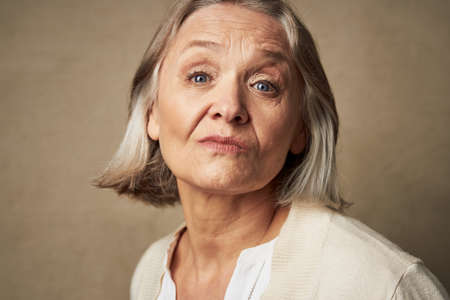 elderly woman in robe face closeup posing isolated background