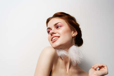 attractive women fluffy earrings nude shoulders cosmeticsの写真素材