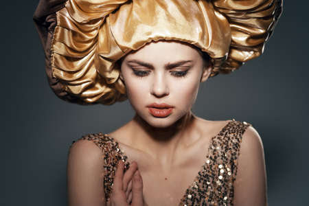 pretty woman in big golden hat vintage lifestyle glamorの写真素材