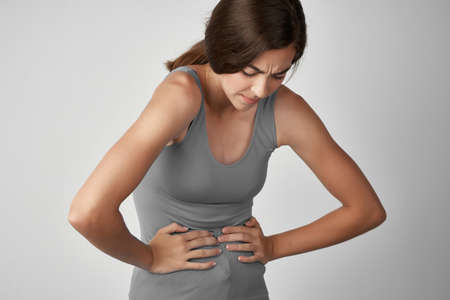 woman gray t shirts abdominal pain menstruationの写真素材