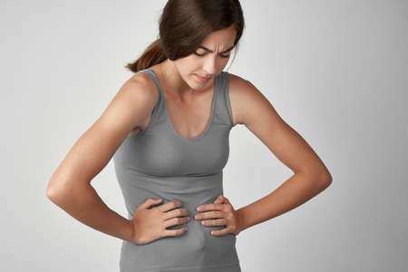 woman in gray t shirt health problems abdominal pain diarrhea