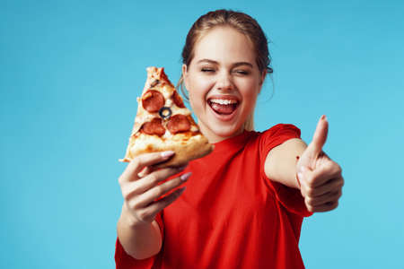 pretty woman with pizza in hands fast food eating funの写真素材