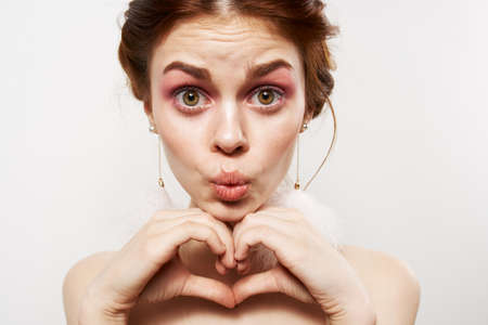 pretty woman with surprised facial expression naked shoulders cosmetics fashionの写真素材