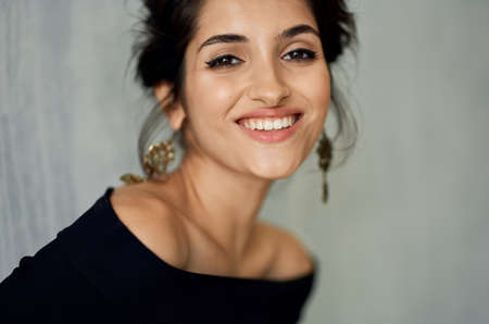 cheerful pretty woman in black dress decoration fashion close-upの写真素材