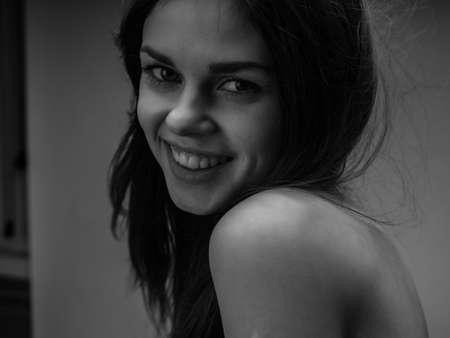 pretty woman posing naked back studio black and white photoの写真素材