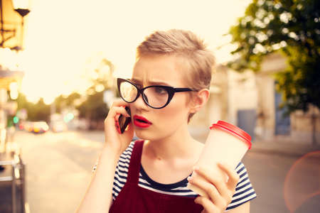 pretty woman outdoors talking on the phone lifestyle summer close-up