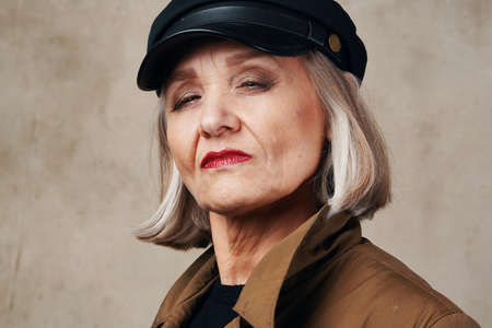 elderly woman in coat posing fashion autumn styleの写真素材