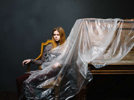 woman near piano posing fashion music