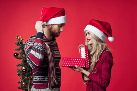 cheerful young couple gift holiday family red background christmas