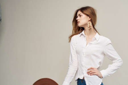 attractive woman in white shirt hat in hand decoration posing hairstyleの写真素材