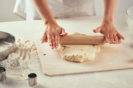 rolling dough on the table flour products kitchen workの写真素材