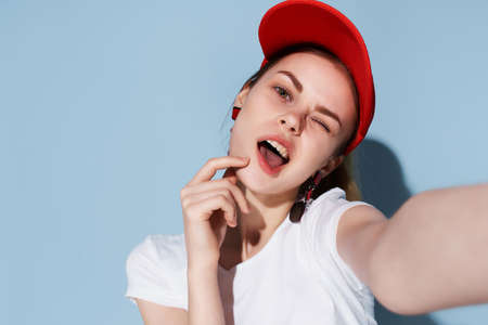 pretty woman in white t-shirt red cap summer fashion fun posing