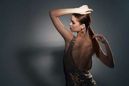 woman in golden dress posing jewelry fashion studio