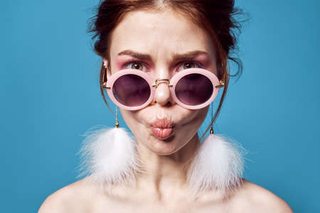 pretty woman in sunglasses bare shoulders fun young close-upの写真素材