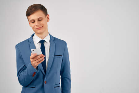 business man in a suit with a phone in his hands internet communication technology