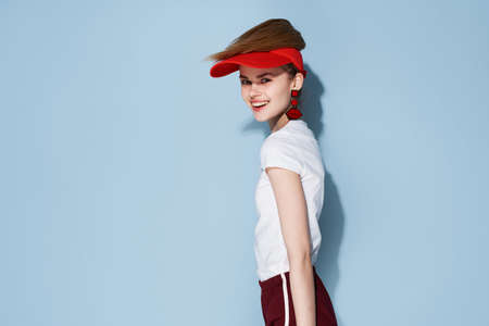 attractive girl in red cap summer clothes fashion posingの写真素材