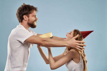 cheerful young couple celebration birthday fun cake entertainmentの写真素材