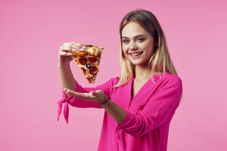 cute cheerful woman pizza in hands snack delicious fast food pink background