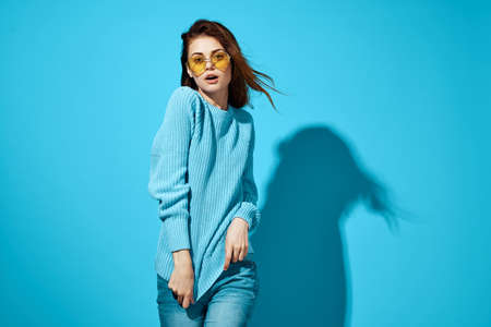 portrait of a woman in a blue sweater blue background Lifestyle