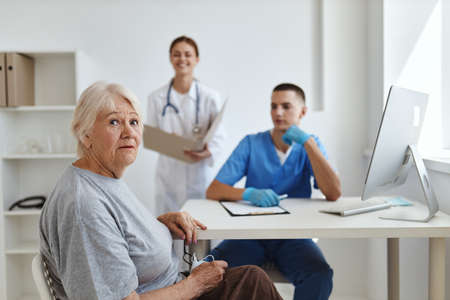 elderly woman patient in hospital nurse and doctorの写真素材