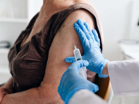 An elderly woman being vaccinatedの写真素材