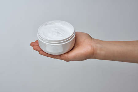 cream in female hands moisturizing dermatology skin careの写真素材