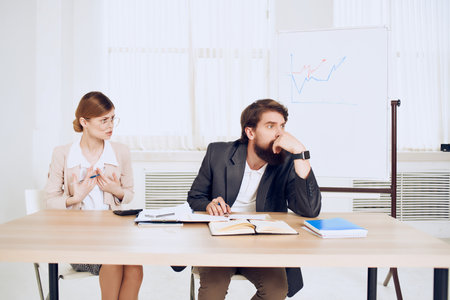 business man and woman communication emotions work colleaguesの写真素材