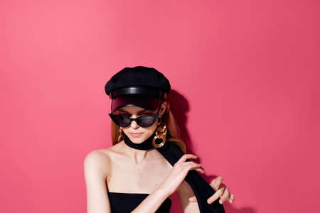 pretty woman in a black dress makeup pink backgroundの写真素材