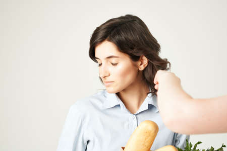 smiling woman with package of groceries groceries supermarket lifestyle