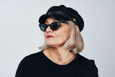 fashionable elderly woman wearing sunglasses posing close-upの写真素材