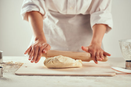 rolling dough on the table flour products kitchen work. High quality photo