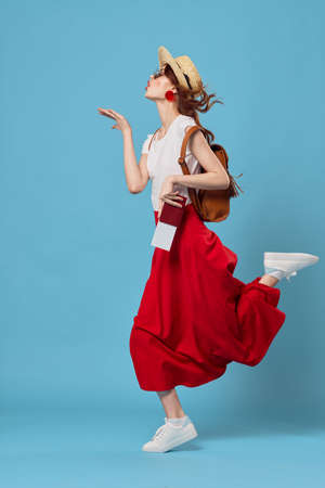 pretty woman with a red skirt ready for vacationの写真素材