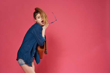 cheerful woman with backpack fashion emotionsの写真素材