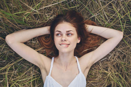 cheerful woman lies on the grass rest lifestyle natureの写真素材